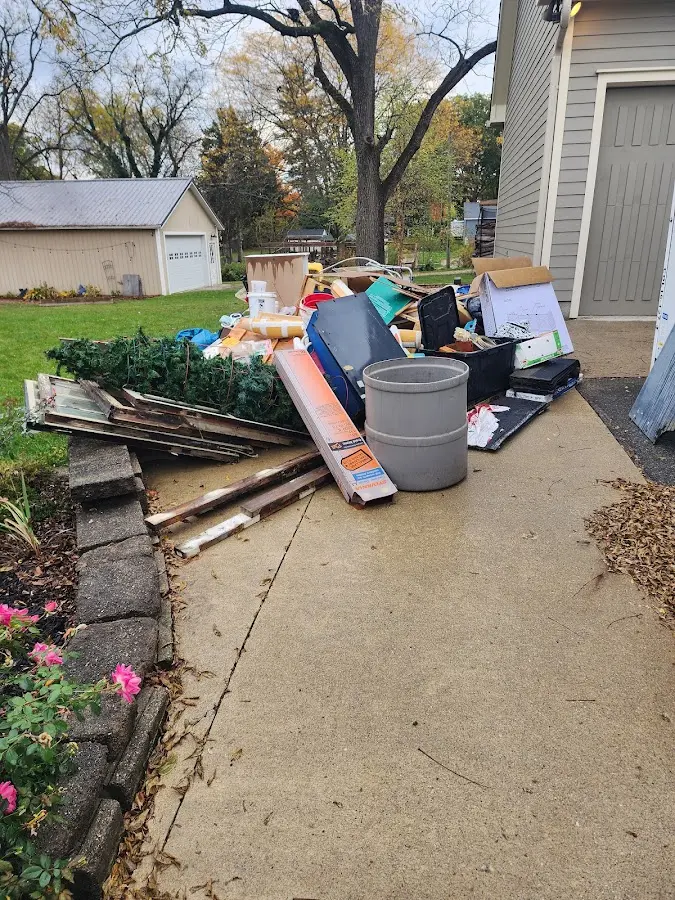 Dumpster being loaded with debris for Estate Cleanout Dumpster Rental in Adams